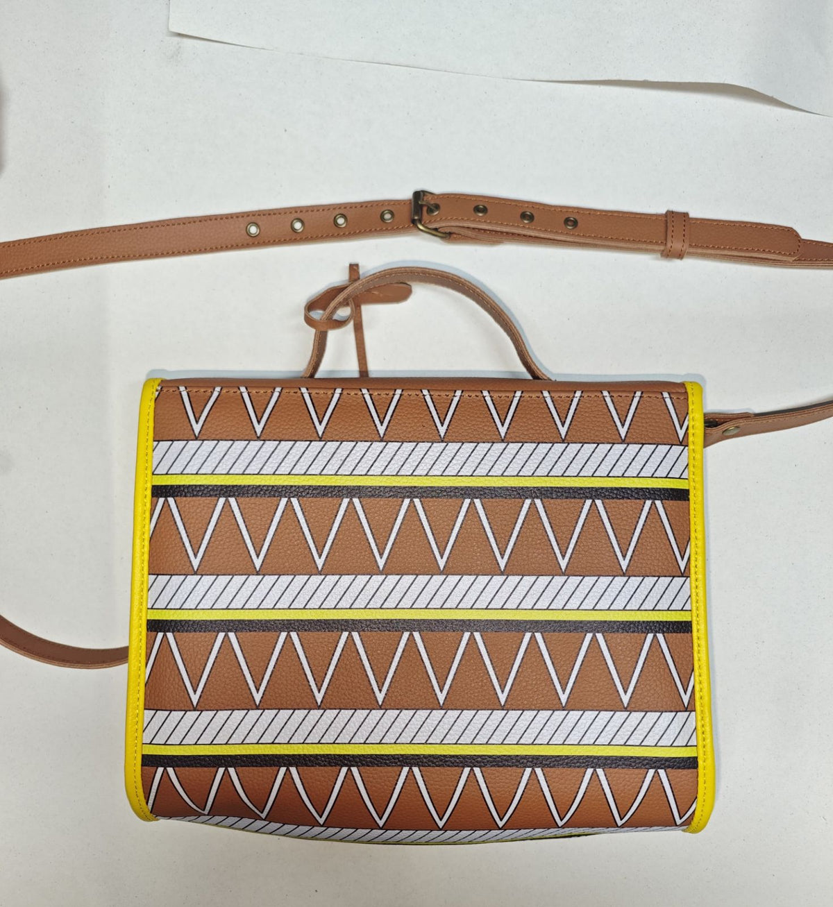 Printed back of the Earthsong style 001 shoulder handbag, with brown leather handle and adjustable strap.