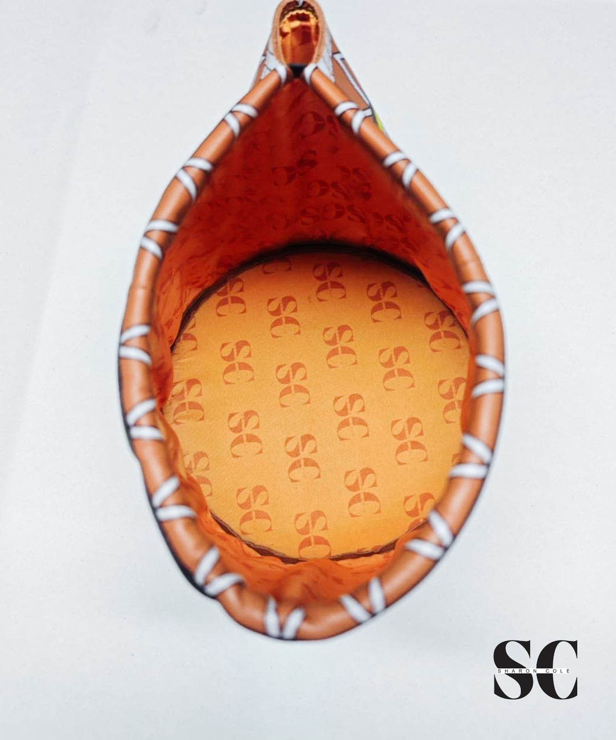 Interior of the Earthsong Nefertiti leather hat showing SC monogram lining and the elastic band at the back rim.