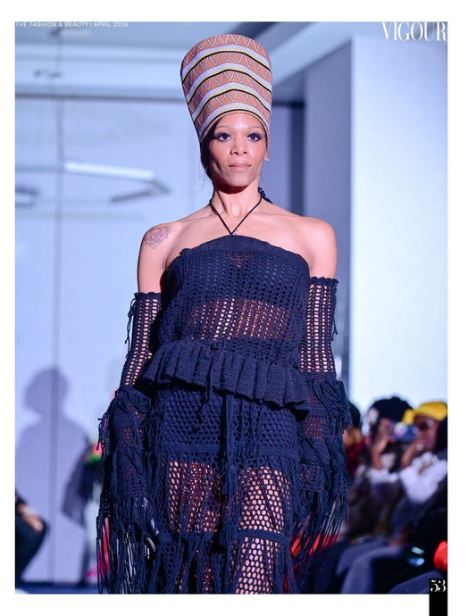 Runway model wearing the Earthsong Nefertiti tribal-print leather hat with a black crochet outfit.